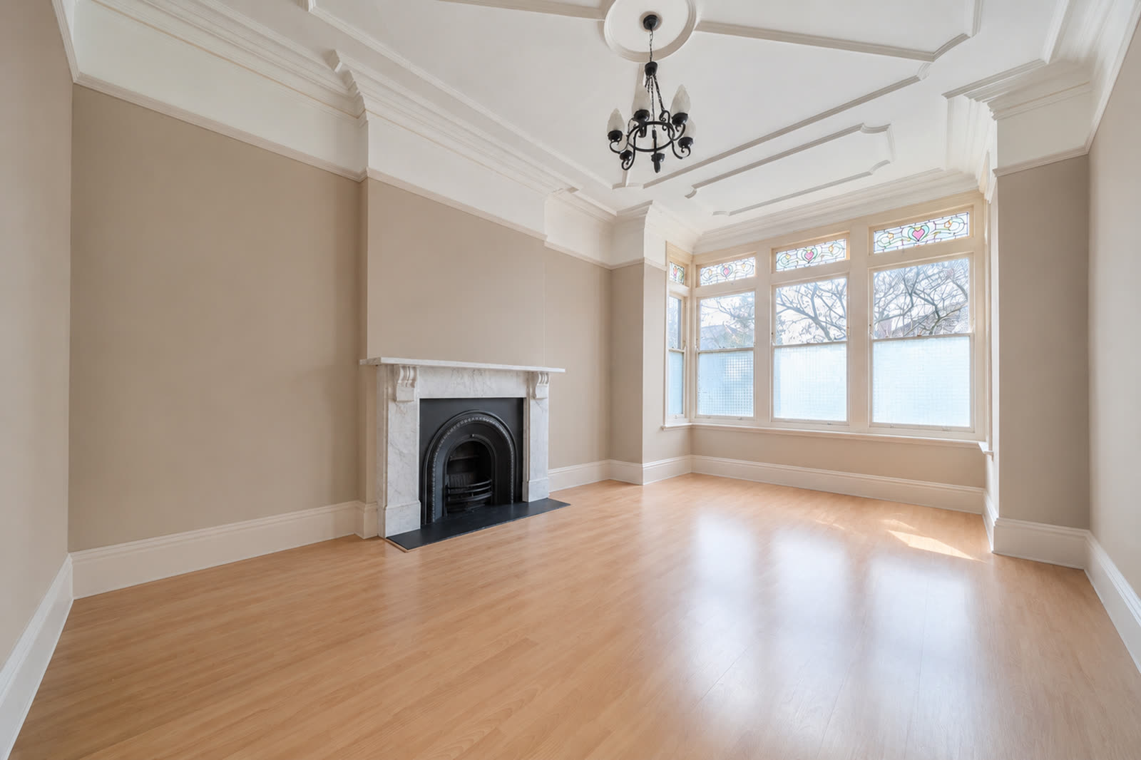 Same living room digitally cleared. Shelves removed, curtains gone, walls repainted, floor swapped