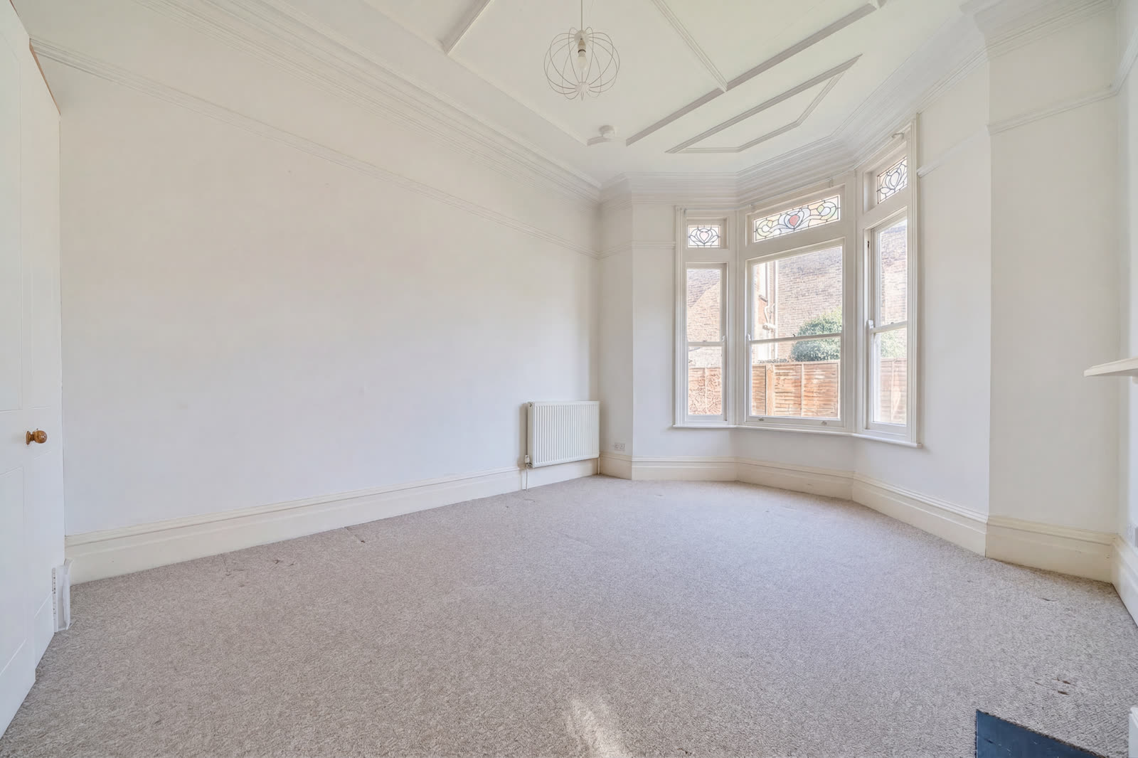 Same bedroom digitally cleared. Shoeboxes and clutter gone, walls neutralised, fresh carpet